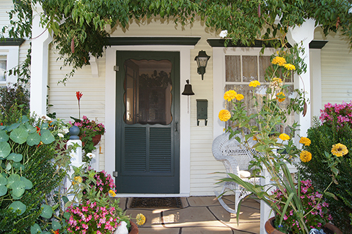 A lushly landscaped entrance to a Craftsman home